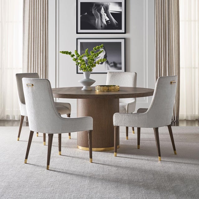 Meticulously designed and beautifully constructed, this round dining table features a light Martini finish that highlights...