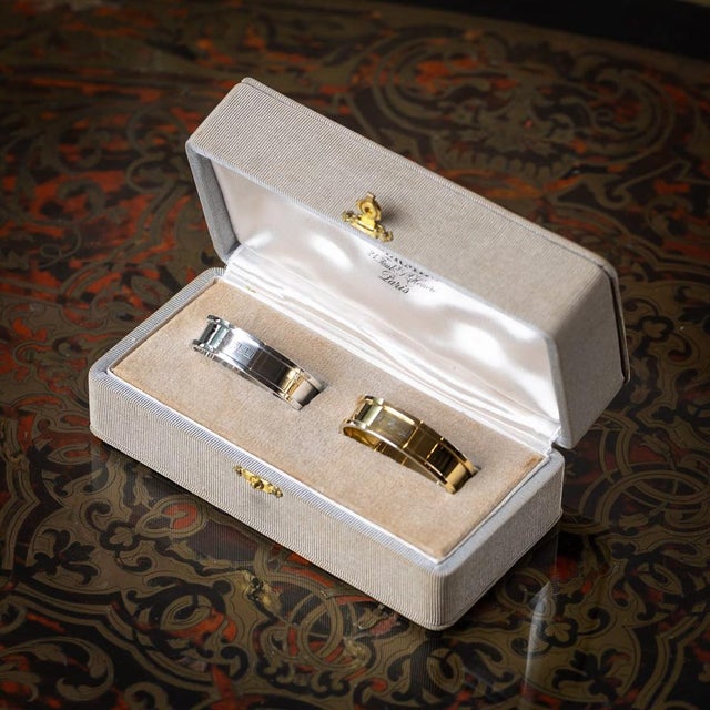 A stylish pair of mid 20th century french solid silver-gilt hermès napkin rings. One crafted in gilt silver and the other...