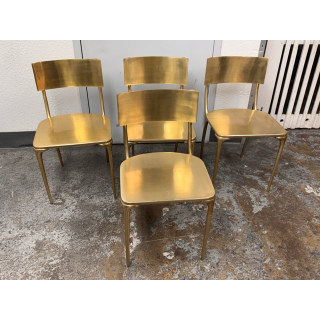 Design Plus Gallery presents a Set of Four Indoor/Outdoor Oro Gold Dining Chairs from CB2. Each chair has a polished...
