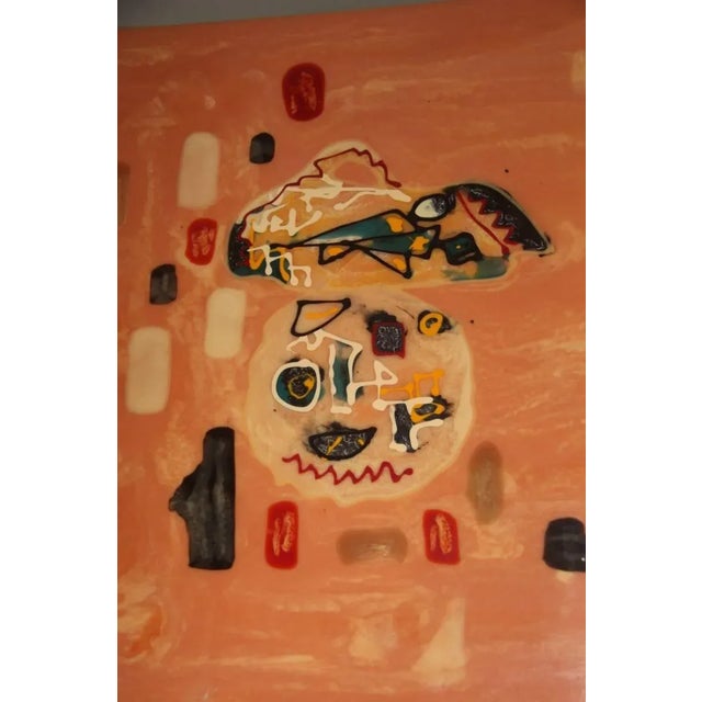 This painted resin coffee table with metal feet is in the style of Enrico Baj.