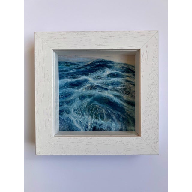 This artwork captures the dynamic movement of waves, rendered in rich shades of blue and green, suggesting both depth and...