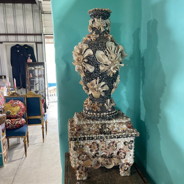 A vintage large shell vase on a separate shell pedestal originally from a collection in Florida. The vase and pedestal are...