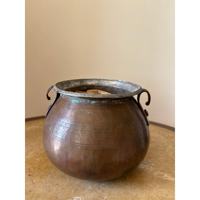 This traditional handcrafted copper pot has hand forged handles and a a heavy aged patina. Originally it was a staple in...