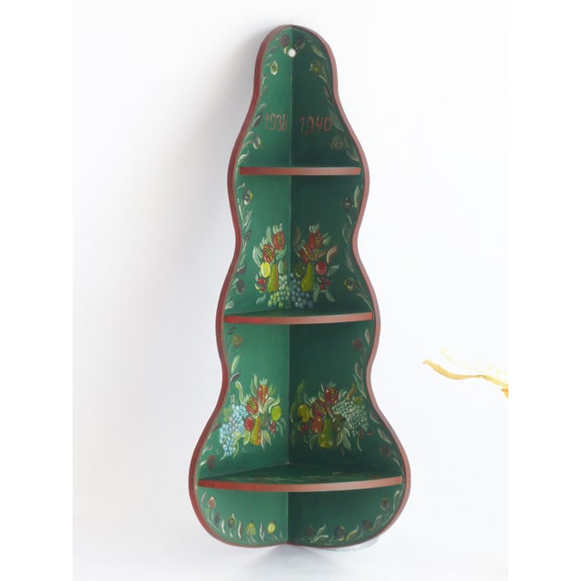A wooden vintage Folk Art wall cabinet with hand painted flowers and fruits. The beautiful corner cabinet is painted in...
