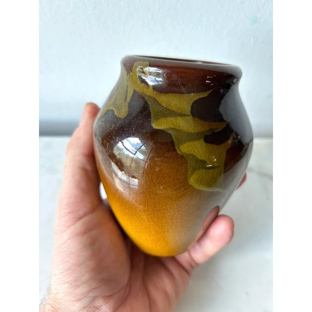 This 1904 Rookwood Pottery Dandelion Vase by Irene Bishop is a testament to the timeless beauty of artisan ceramics....