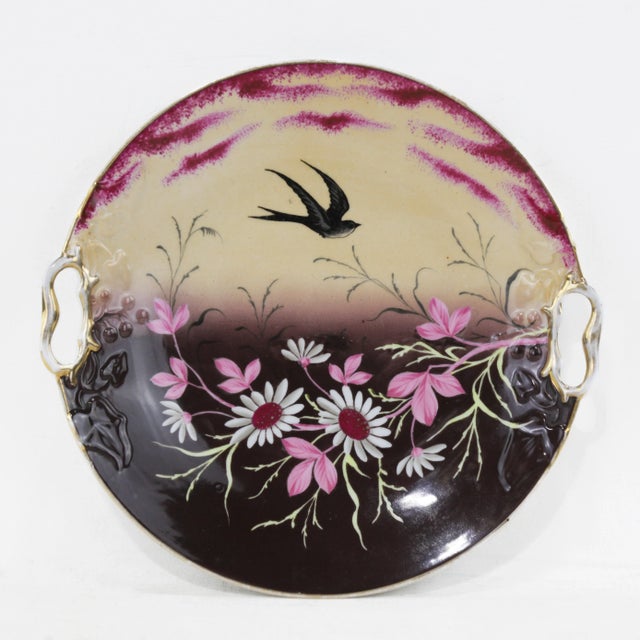This stunning pair of vintage porcelain plates showcases hand-painted swallows in flight, surrounded by beautifully...