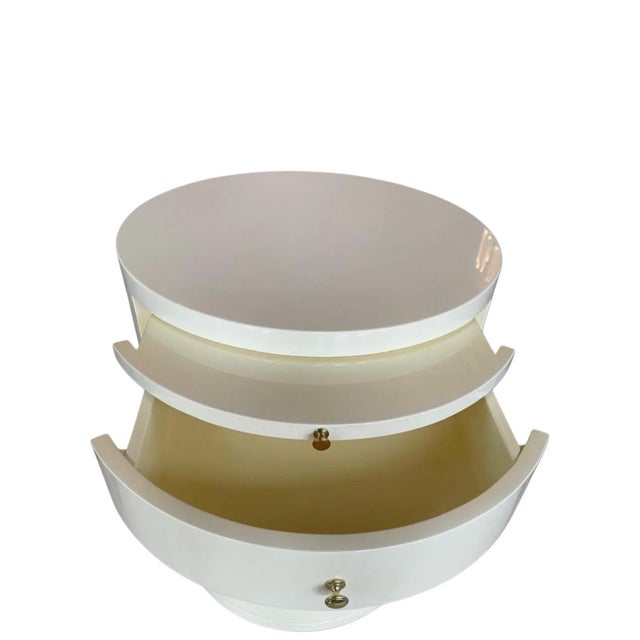 Refined custom cylindrical cabinet table by William Switzer, produced 2018, finished in a high-gloss cream-white lacquer...