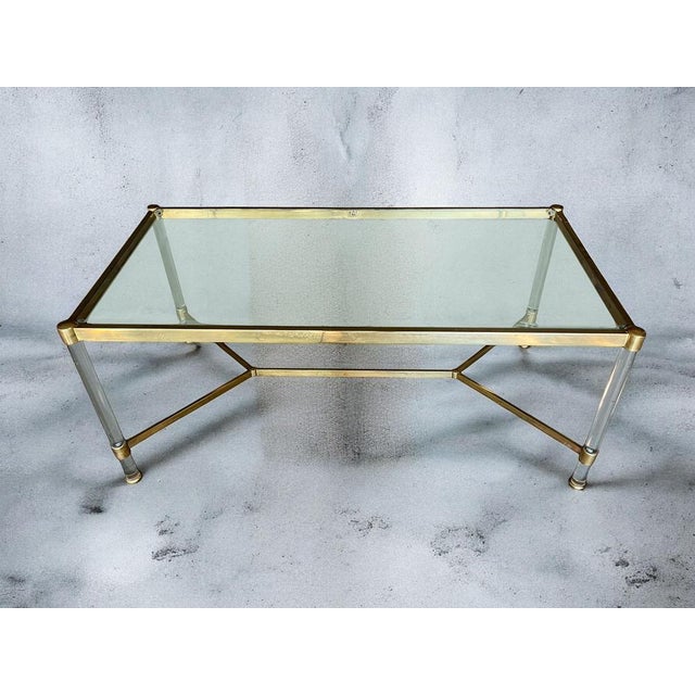 Beautiful elegant large coffee or side table, brass and acrylic glass legs with a glass table top. Italian production from...