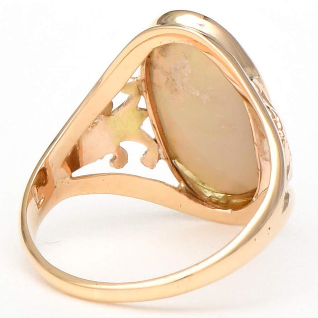 Brilliant reflections of colors play on the surface of this gorgeous gray opal set in elegant filigree gold. Indulge your...