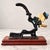 Charming vintage cast iron nutcracker featuring a beautifully detailed, hand-painted soldier figure mounted on a rich wood...