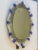 Spectacular oval mirror with Murano glass transparent elements and blue flowers. Oval mirror with venetian hand-carved...
