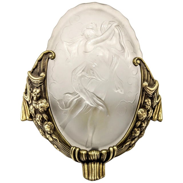 A pair of French Art Deco wall sconces by the French artist "Muller Freres". Molded clear frosted glass shades decorated...