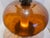 Striking oversized vintage table lamp featuring a dramatic amber smoked glass globe body with ornate antiqued metal...