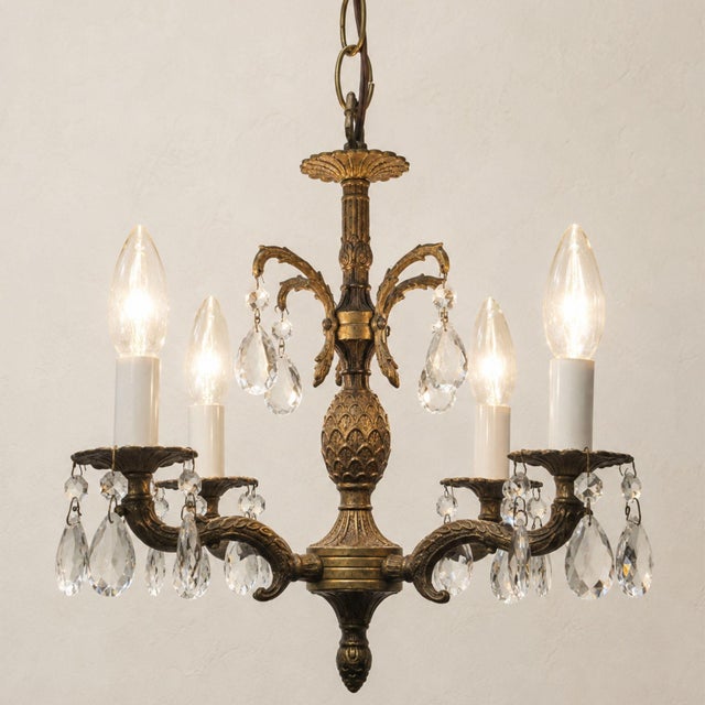 Circa 1960s petite four-light chandelier with a pineapple-form center, scrolling foliate arms, scalloped bobeches and a...