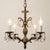 Circa 1960s petite four-light chandelier with a pineapple-form center, scrolling foliate arms, scalloped bobeches and a...