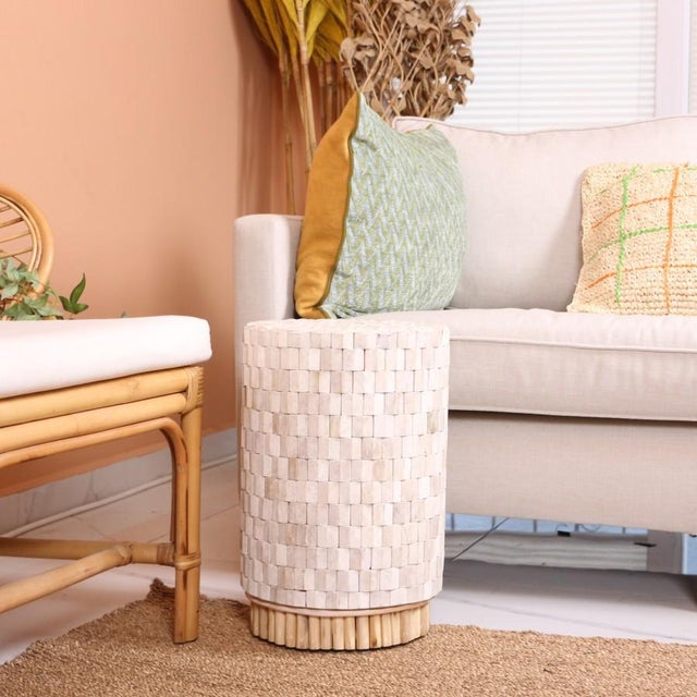 Our product is meticulously handcrafted by skilled artisans, featuring a natural rattan base and a solid teak wood top....