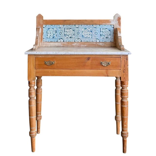 An English pine washstand, circa 1880, displaying the simple elegance and functional craftsmanship associated with the...