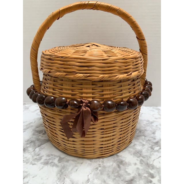 Vintage wood woven decor or storage basket with top handle and lid closure along with two strands of rustic large Tagua...