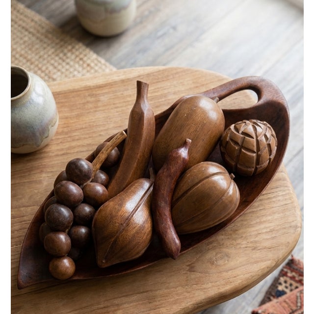 ​A quintessential statement piece of mid-century tropical modernism, this striking 8-piece hand-carved monkey pod wood...