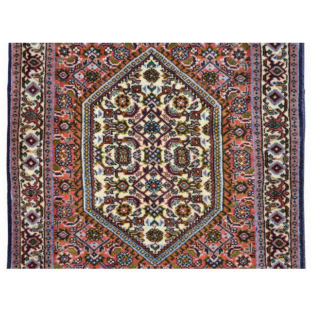 A wonderful vintage Persian Bidjar rug with a diamond medallion with a stylized floral pattern amidst a field of more...