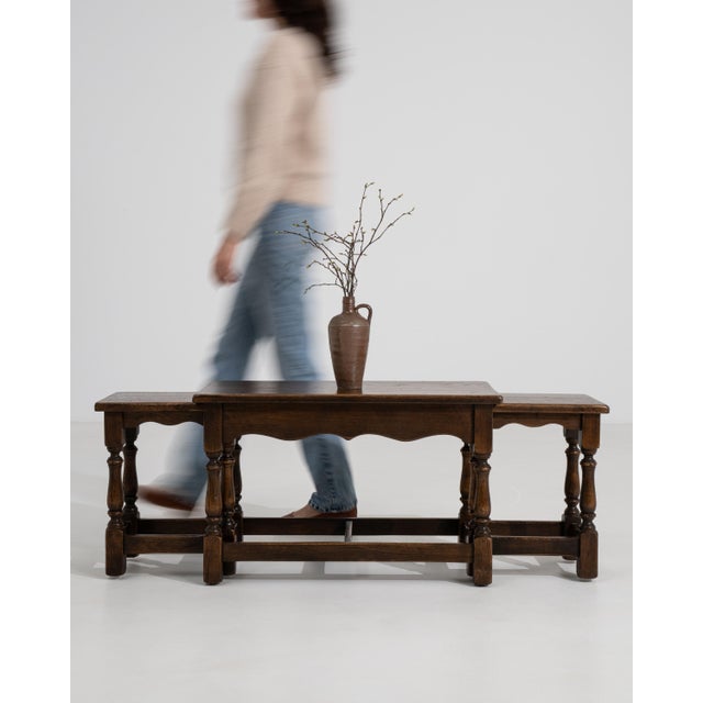 A set of three oak nesting tables from France, dating to circa 1970, designed with a rectangular form and staggered...