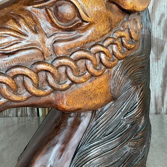 Add a touch of artisanal craftsmanship to your space with this striking hand-carved wooden horse head bust. Showcasing...