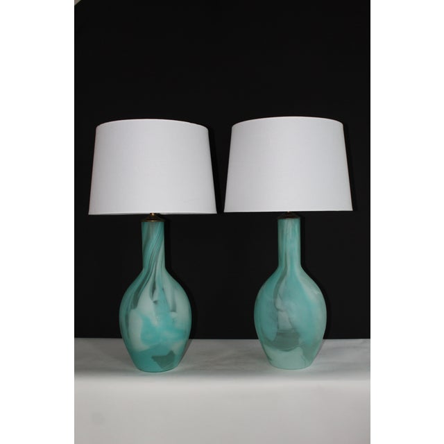 Beautiful pair of Seguso style Murano glass lamps. Hand blown mottled hews of turquoise and porcelain white. Giving an...