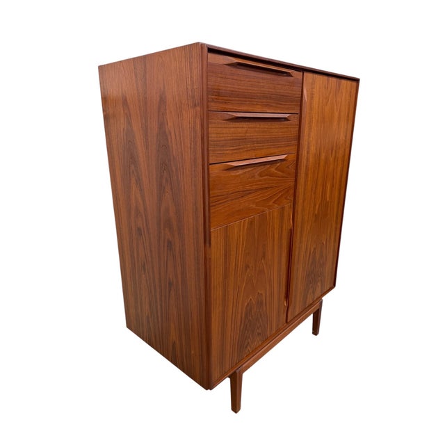 A striking example of Danish modern craftsmanship, this Mid-Century Fredericia Teak Gentleman’s Wardrobe High Chest offers...
