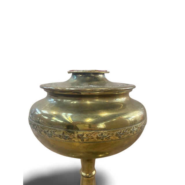 Gilt brass incense burner with floral motifs. The top can be sealed with the small red stopper. Beneath this stopper, a...