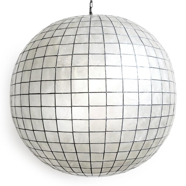 Stunning contemporary globe lantern made from delicate capiz shell square pattern bonded together with pewter finish...