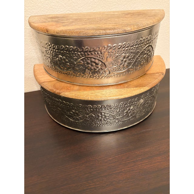 The larger of the pair of metal and wood shelving units are 14 inches long by 7 inches deep and stand about 5 and 1/2...