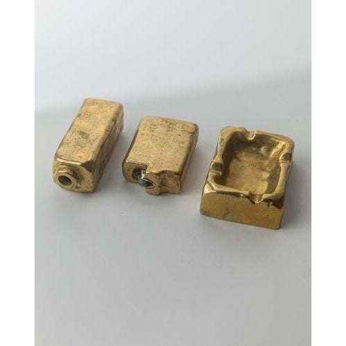 This vintage 1960s Brutalist bronze desk set is a powerful sculptural ensemble, comprising an ashtray, table lighter, and...