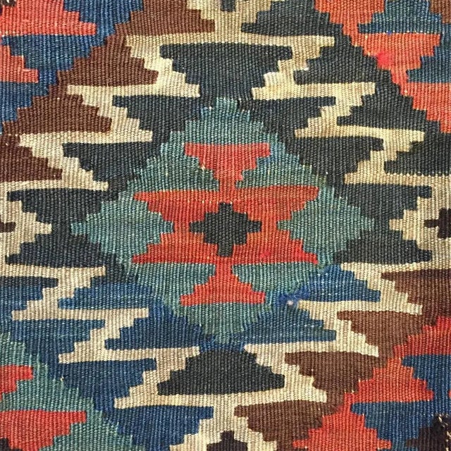 An early 20th Century, Azerbaijani,Shahsavan Kilim rug with a traditional crimson, sage green and indigo diamond pattern...