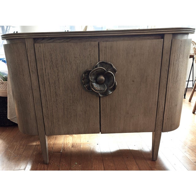 Discover the elegance and functionality of the Briallen Demi-Lune Cabinet from Currey & Company. This exquisite piece...