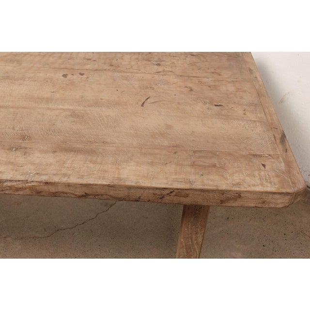 This vintage Chinese writing table is crafted from solid elmwood, dating to the first half of the 20th century. The broad...