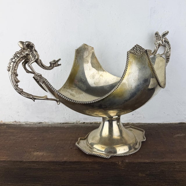 Italian silverplate centerpiece bowl, marked AG. D'Agostino, featuring spectacular dragon-form handles. Raised on a...