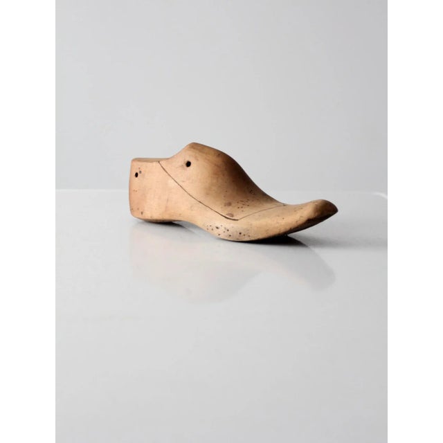 Antique wooden shoe last, a cobbler’s form marked “B” on the top of the foot. The piece features holes at the top for...