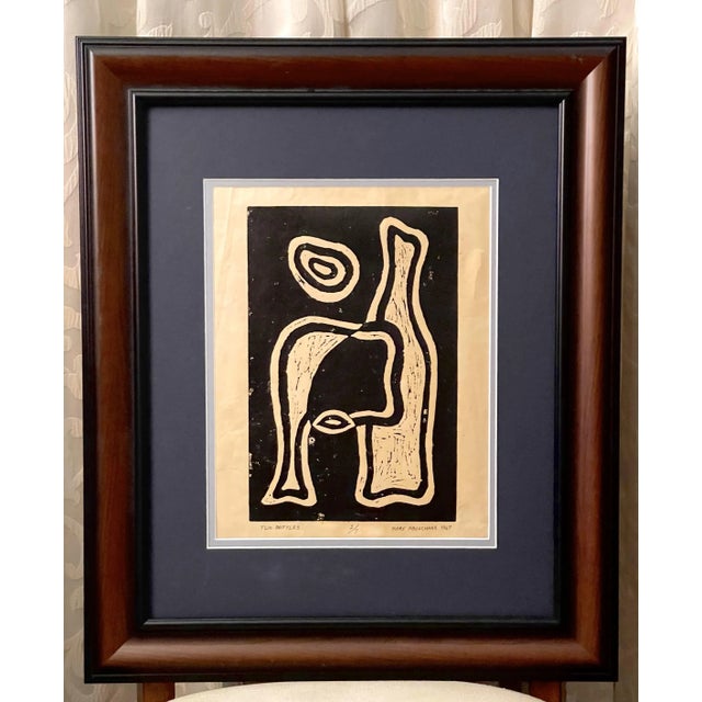 This linoleum print is a modern original arrangement of two bottles created by Mary Abouchaar. It depicts two bottles side...