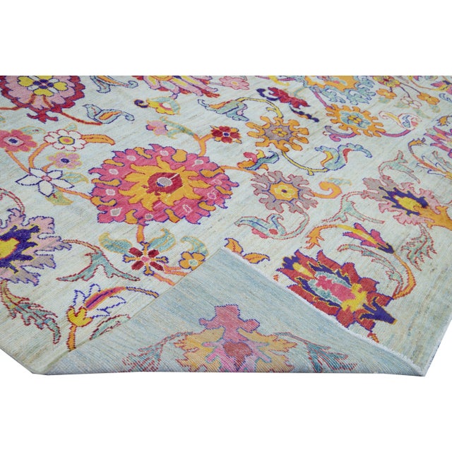 Beautiful modern Oushak hand-knotted wool rug with a blue gradient field. This Oushak rug has a pink, yellow, orange, and...