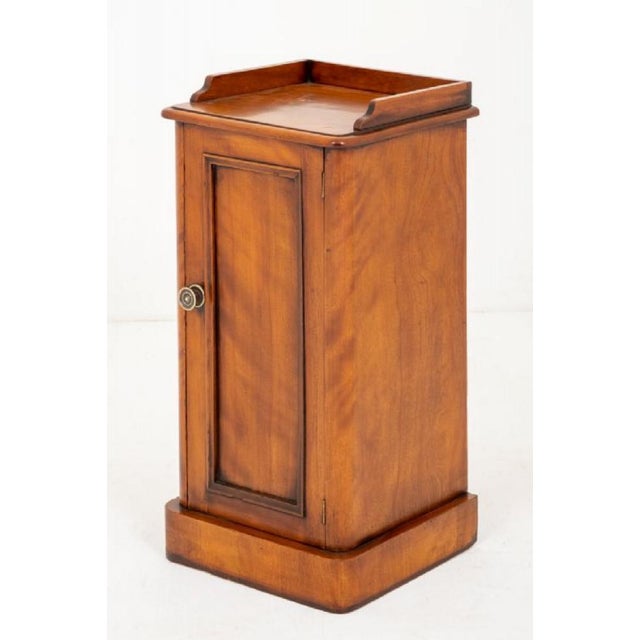 Victorian Satin Birch Bedside Cabinet. having a plinth base and rounded corners. Circa 1870 The panelled door with a brass...