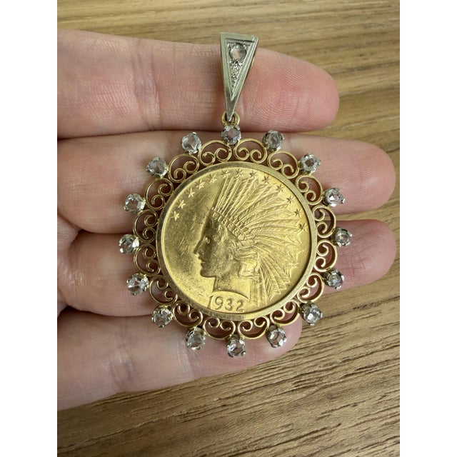 A magnificent and distinctive 1932 United States $10 Indian Head gold coin pendant, framed within an elaborately detailed...