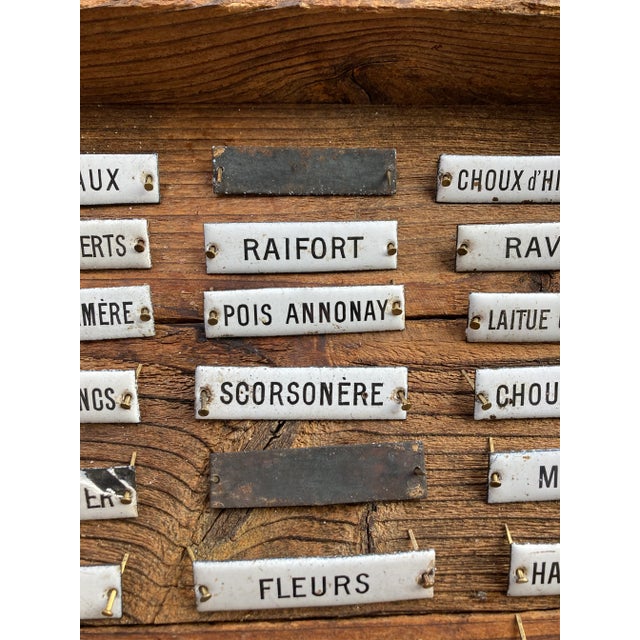 Delightful set of 32 early 20th century French herb/vegetable enameled labels. These were affixed to the front of drawers...