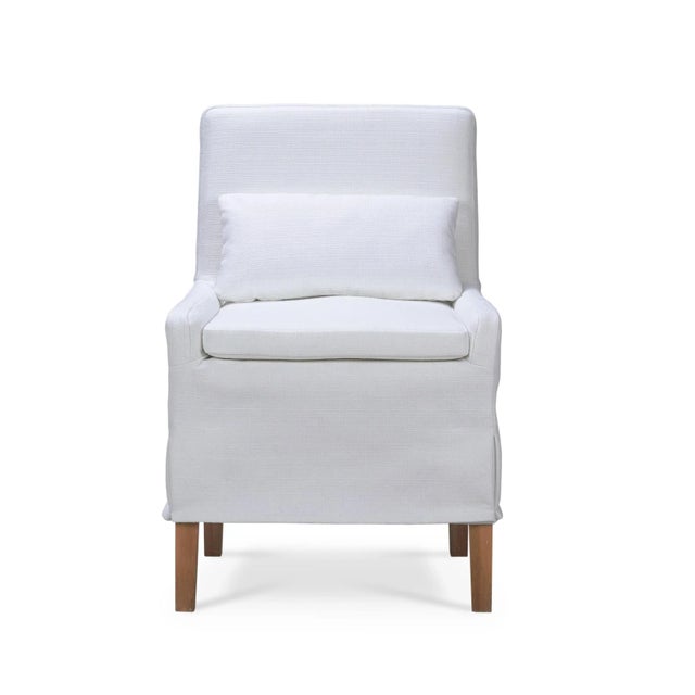 A perfect blend of timeless elegance and modern functionality. This relaxed dining chair features a solid wood frame...