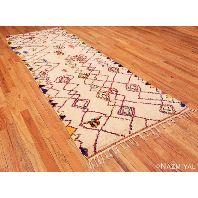 This vintage shaggy Moroccan Azilal rug from Morocco features diagonal shapes and strong, rigid lines to create a...