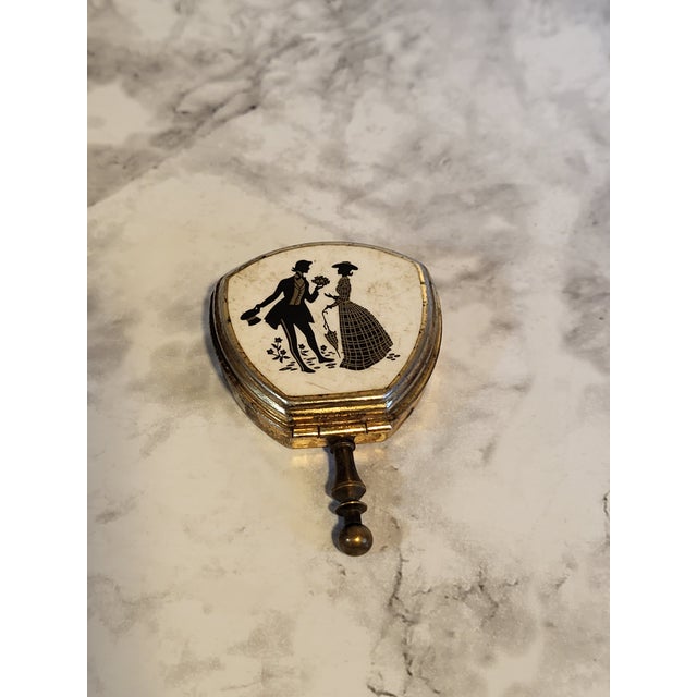 This Portable Pocket Ashtray is a handmade piece origination is unknown. It features a charming couple image, making it a...