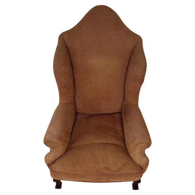 An impressive 20th-century English wingback armchair, finely crafted from beech and distinguished by its exceptionally...
