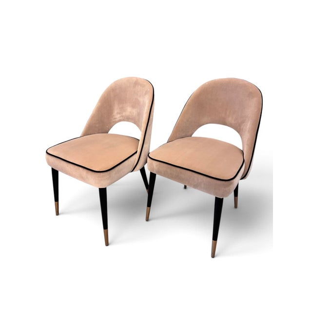 A sophisticated pair of Cliff dining chairs by Eichholtz, upholstered in supple taupe Alcantara with elegant black piping...