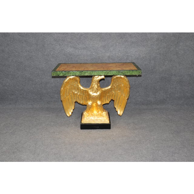 This fine water-gilded George II carved walnut and faux marble eagle console table is a masterful example of 18th-century...