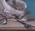 Everyone's Favorite Game by Kelly Birkenruth | Oil on panel Still life with newspaper, rock, and scissors For Sale - Image 4 of 5