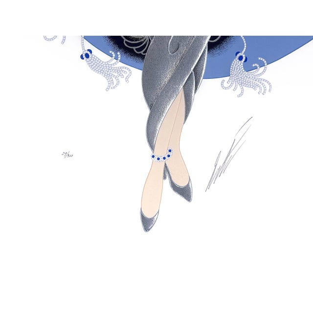 Embossed serigraph with hot stamping on paper. Hand signed by Erte lower right. Hand numbered 29/300 lower left. Artwork...